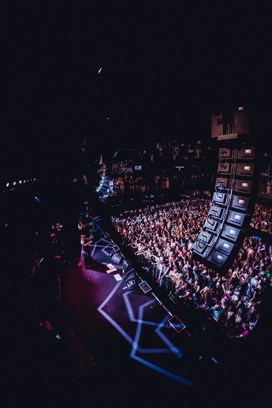 Aerial view of a stage and packed crowd at a live show